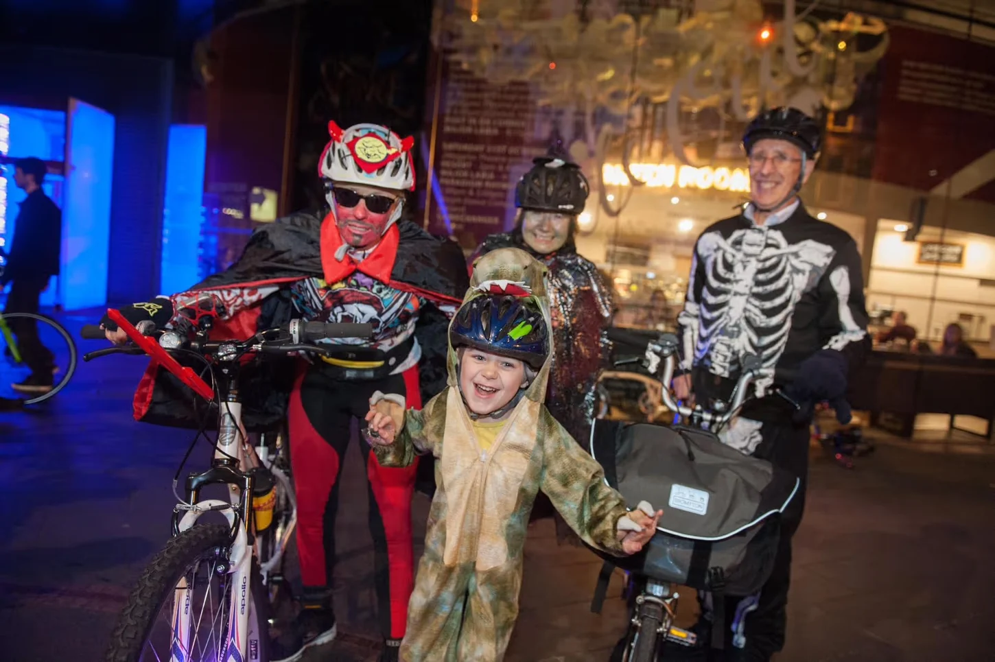 Family members and cyclists dressed for a Halloween bike ride